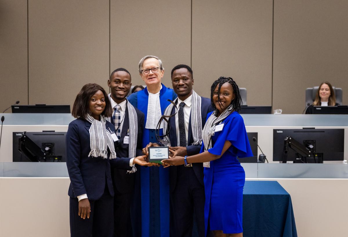 Pictured here: The presiding judge of the competition’s jury, Judge Perrin de Brichambaut, with the winning team ©ICC-CPI