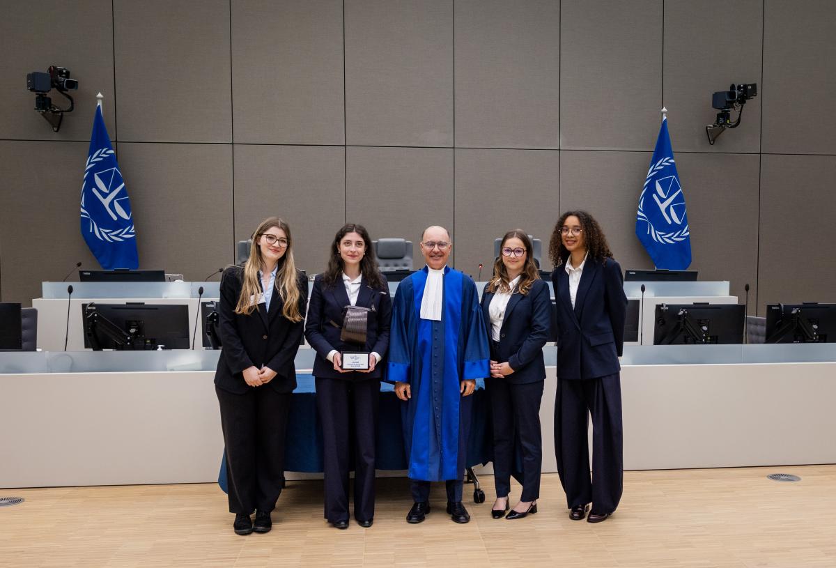 Pictured here: The presiding judge of the competition's jury, Judge Ben Mahfoudh, with the winning team ©ICC-CPI